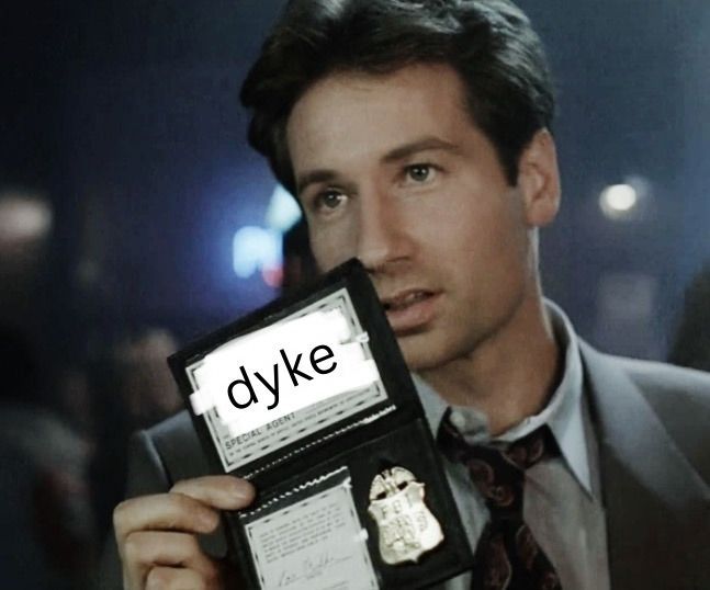 fox mulder from the x-files holding up a badge labeled 'dyke'